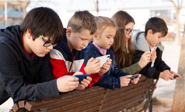  kids on phone in line  Read More: S4 Ep. 20 – Training the Algorithm: Helping Your Children Navigate Social Media